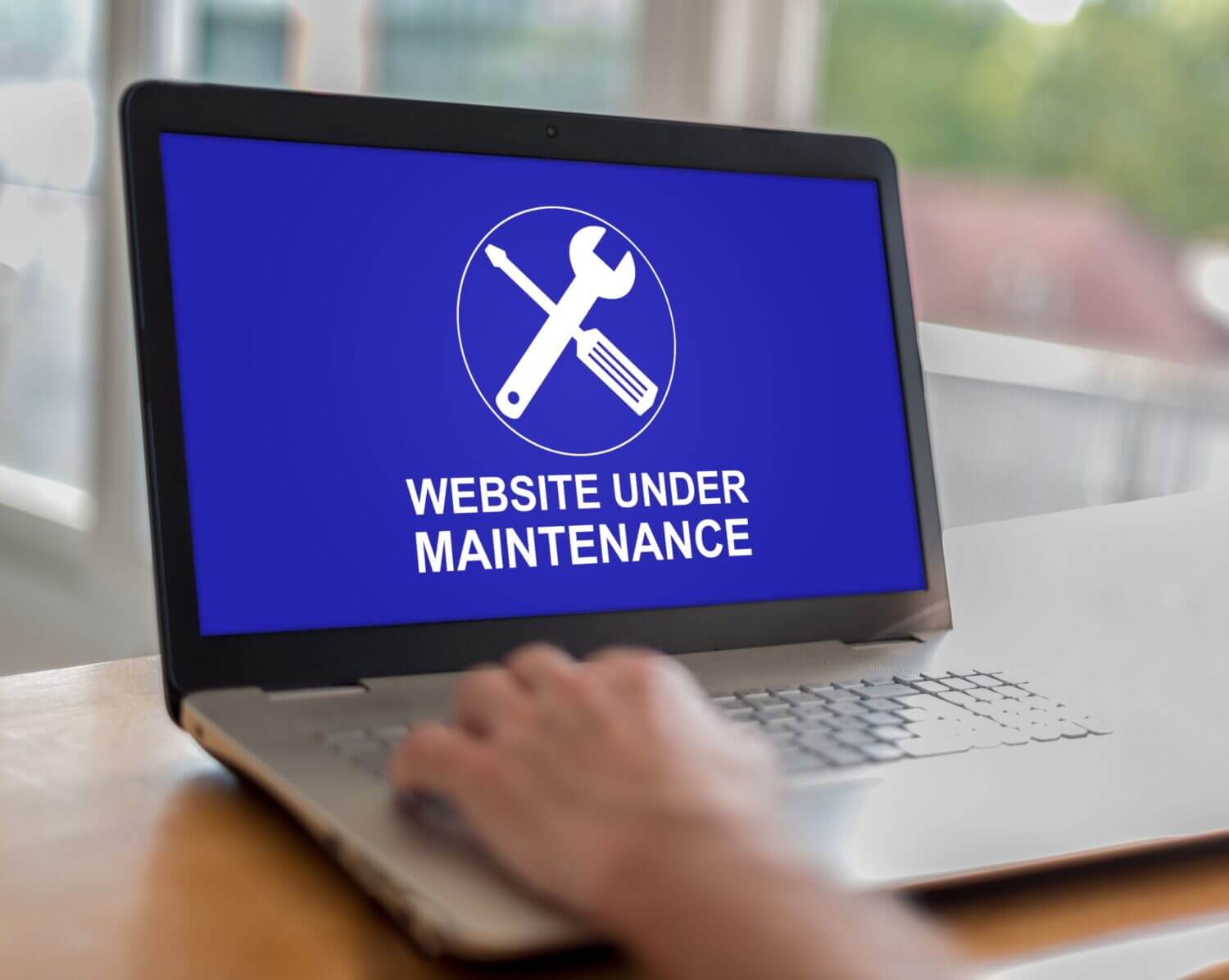Website Maintenance Graphic on a laptop screen